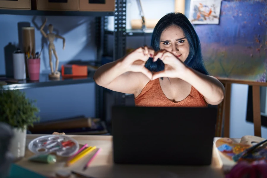 Professional content creator workspace setup with laptop, ring light, and camera equipment for OnlyFans content creation in 2025